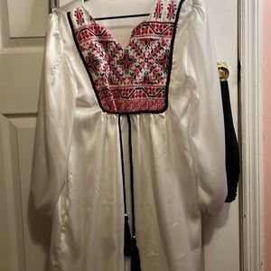 White blouse hand sewn cross-stitch embroidery. Traditional Palestinian Tatreez.